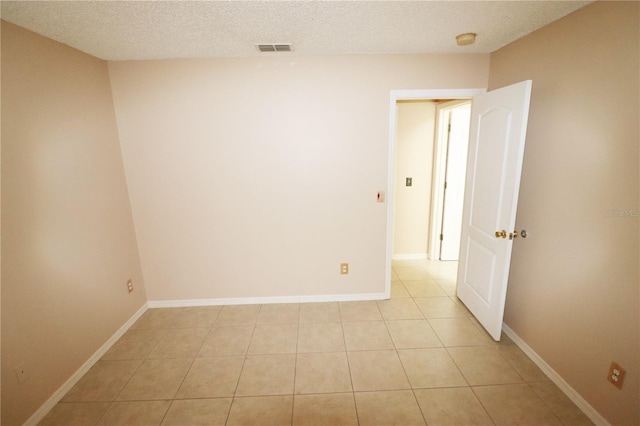 2521 Tamarind Dr, Edgewater, FL 32141 - unfurnished room with baseboards, visible vents, a textured ceiling, and light tile patterned flooring