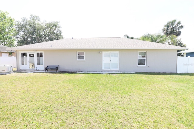 2521 Tamarind Dr, Edgewater, FL 32141 - back of property featuring fence, stucco siding, a yard, and roof with shingles