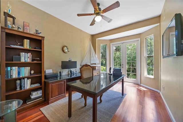 office area with baseboards, wood finished floors, and ceiling fan