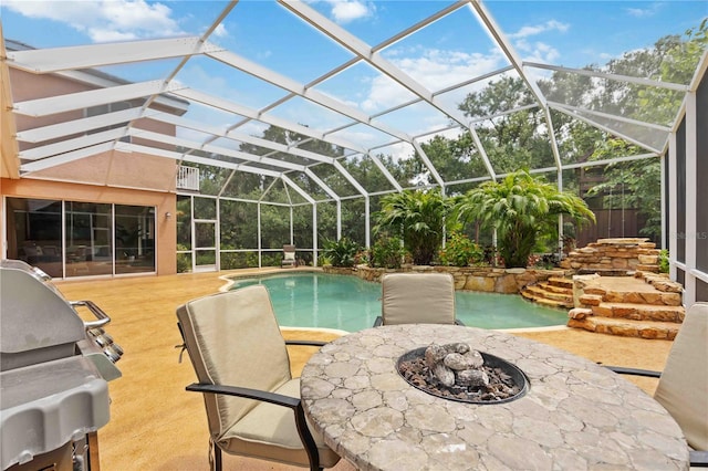 view of pool with an outdoor fire pit, a patio, a lanai, and a grill