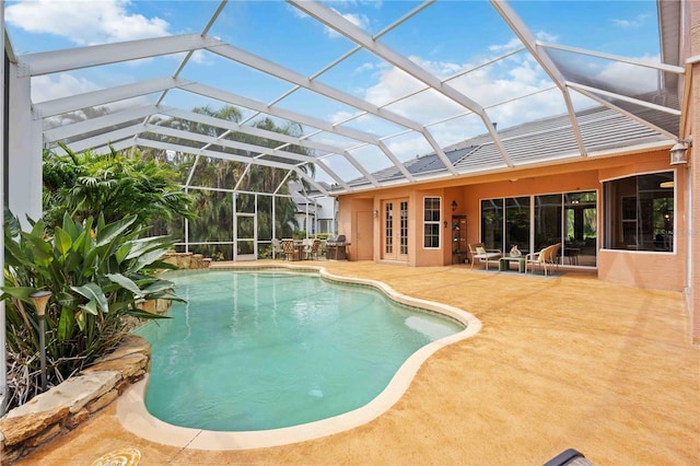 outdoor pool featuring a patio area and french doors