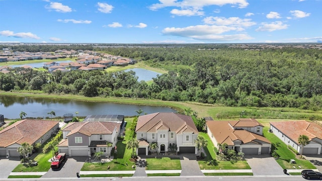 aerial view with a water view, a residential view, and a wooded view