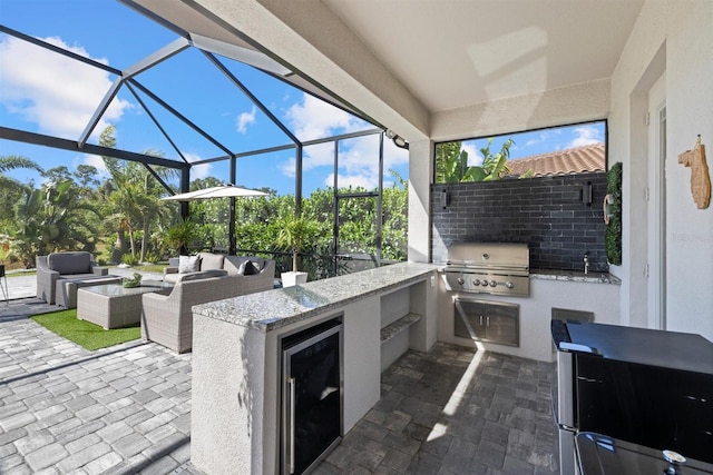 view of patio / terrace with a grill, outdoor lounge area, a lanai, and an outdoor kitchen