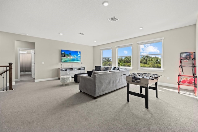 living room with baseboards, visible vents, and carpet