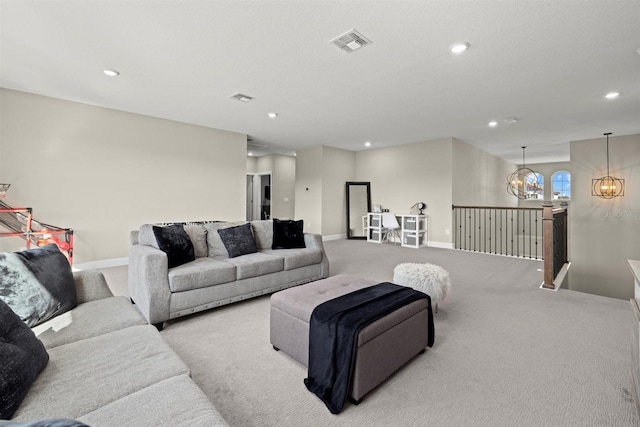 living room with visible vents, recessed lighting, baseboards, and light carpet