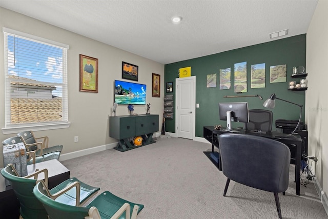 office area featuring baseboards, carpet flooring, a textured ceiling, and visible vents