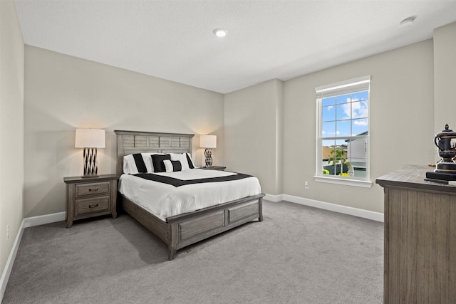 carpeted bedroom featuring baseboards