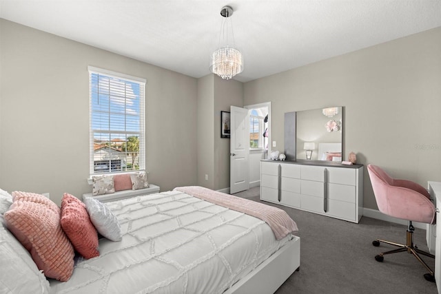 bedroom featuring carpet flooring, baseboards, and a notable chandelier
