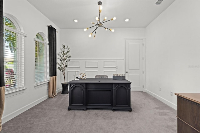 office area featuring a chandelier, light colored carpet, and plenty of natural light