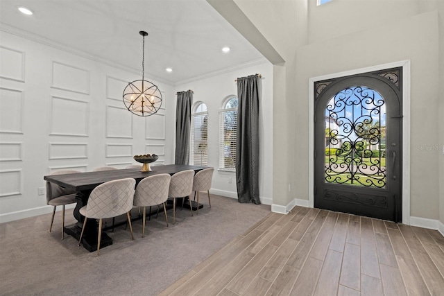 foyer with ornamental molding, baseboards, recessed lighting, a chandelier, and light wood finished floors