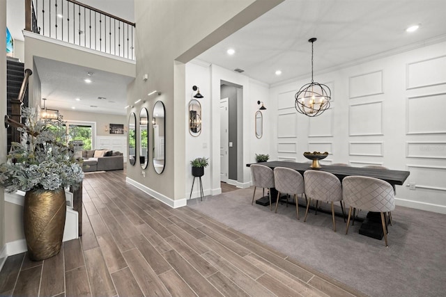 dining area with baseboards, recessed lighting, wood finished floors, and a notable chandelier