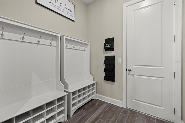 mudroom featuring baseboards and dark wood finished floors
