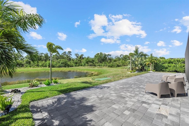 surrounding community with a lawn, a water view, and a patio area