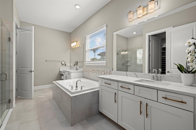 bathroom with a sink, tile patterned floors, a shower stall, and two vanities