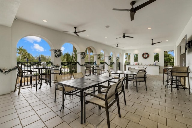 view of patio / terrace with an outdoor bar and a ceiling fan