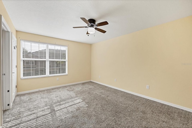 unfurnished room featuring carpet floors, baseboards, and ceiling fan