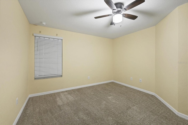 spare room featuring baseboards, carpet flooring, and ceiling fan