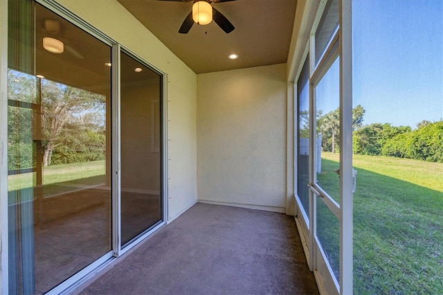 unfurnished sunroom with a ceiling fan