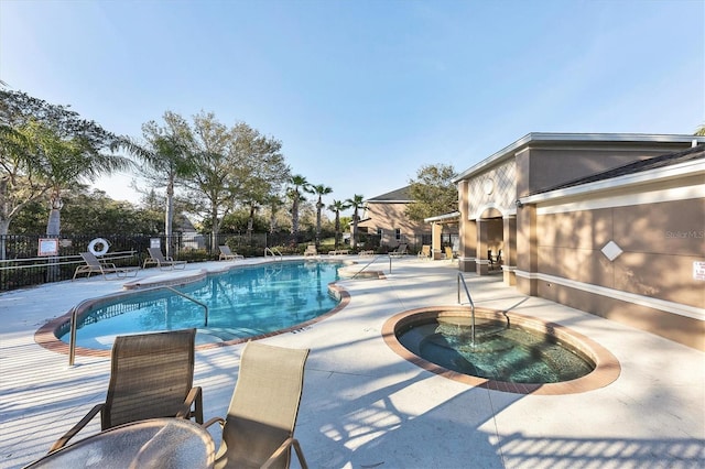 pool featuring fence, a patio, and a community hot tub