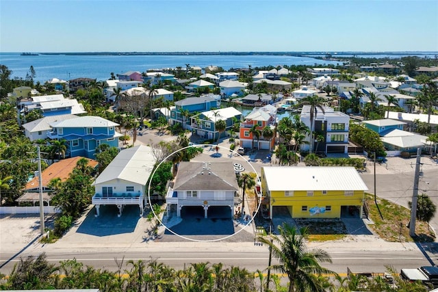 drone / aerial view with a residential view and a water view