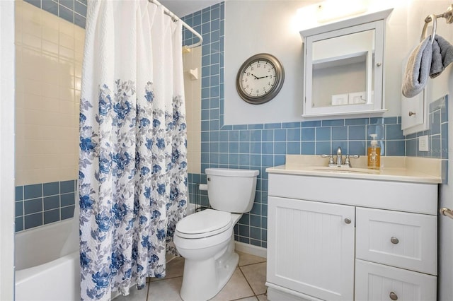 full bathroom featuring tile walls, tile patterned floors, vanity, toilet, and shower / bath combo with shower curtain