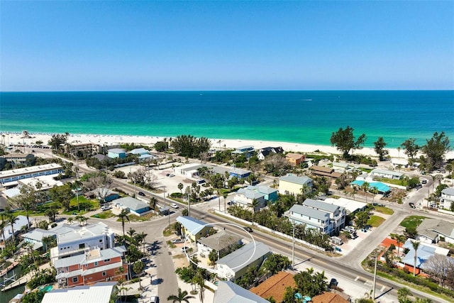bird's eye view featuring a water view and a beach view
