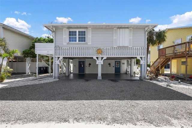 view of front facade featuring a carport, driveway, and stairway