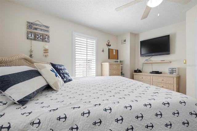 bedroom with a textured ceiling and ceiling fan