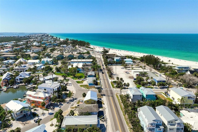 drone / aerial view featuring a water view, a residential view, and a view of the beach