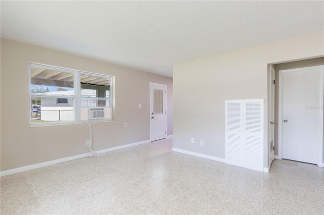 4229 Alna Way, Sarasota, FL 34232 - spare room with speckled floor, baseboards, and cooling unit