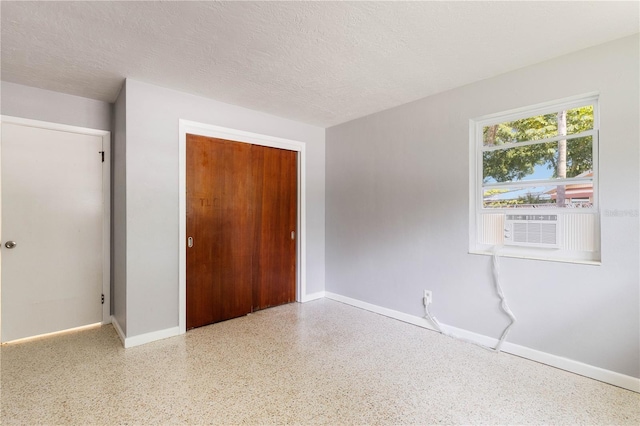 4229 Alna Way, Sarasota, FL 34232 - unfurnished bedroom with speckled floor, baseboards, a closet, and a textured ceiling