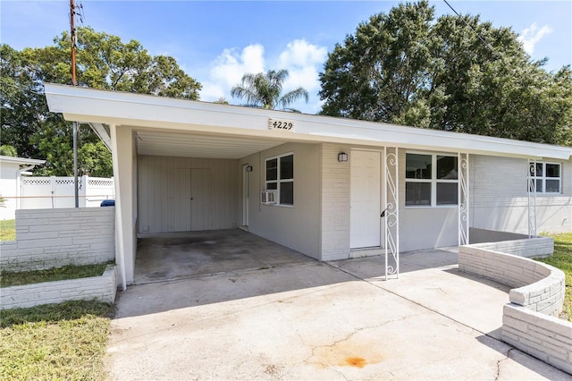 4229 Alna Way, Sarasota, FL 34232 - view of front of home featuring concrete driveway, an attached carport, and brick siding