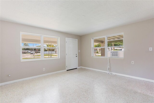 4229 Alna Way, Sarasota, FL 34232 - empty room with speckled floor, baseboards, and a textured ceiling