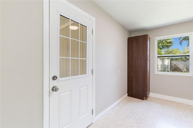 4229 Alna Way, Sarasota, FL 34232 - doorway to outside with baseboards and dark speckled floor