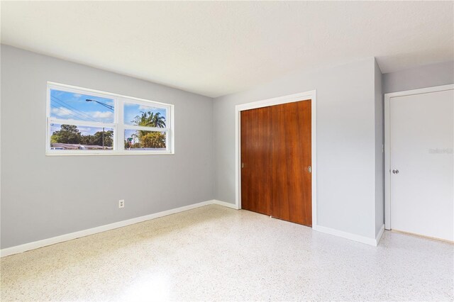 4229 Alna Way, Sarasota, FL 34232 - unfurnished bedroom with speckle patterned floor, a closet, and baseboards
