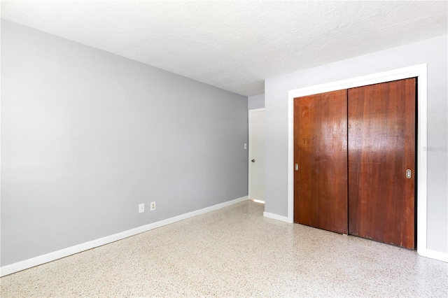 4229 Alna Way, Sarasota, FL 34232 - unfurnished bedroom featuring speckled floor, a closet, and baseboards