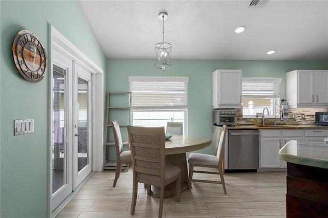 dining area with light wood-style flooring and recessed lighting