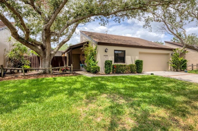 single story home featuring a garage, a front lawn, fence, stucco siding, and driveway
