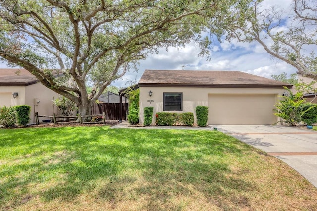 ranch-style house featuring fence, a garage, stucco siding, a front yard, and concrete driveway