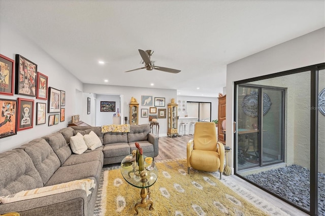 living area with recessed lighting, ceiling fan, and wood finished floors