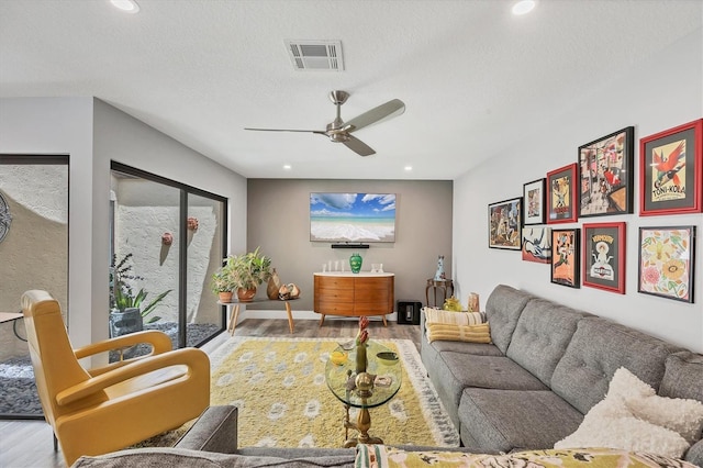 living room featuring recessed lighting, ceiling fan, visible vents, and wood finished floors