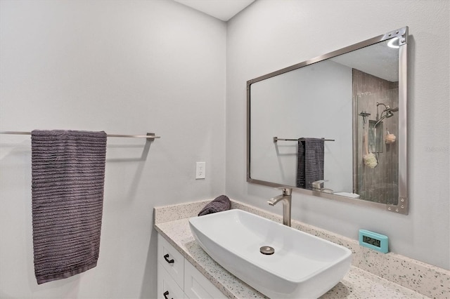 bathroom with walk in shower and vanity