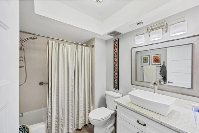bathroom with toilet, visible vents, shower / bath combo, and vanity