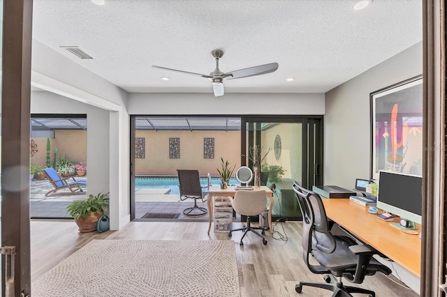 office area featuring ceiling fan, a textured ceiling, visible vents, recessed lighting, and light wood-style flooring