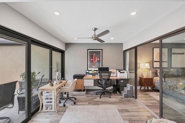 home office with light wood-type flooring, a ceiling fan, and recessed lighting
