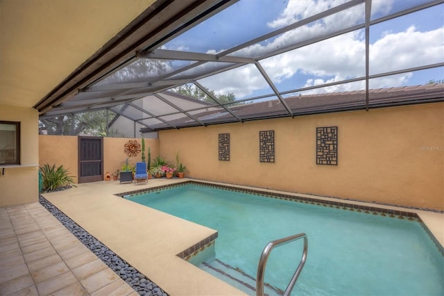 pool featuring glass enclosure and a patio area