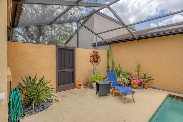 view of patio featuring a lanai and a pool