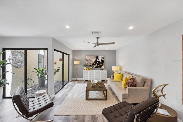 3955 Glen Oaks Manor Dr, Sarasota, FL 34232 - living room featuring light wood-style floors, healthy amount of natural light, recessed lighting, and a ceiling fan