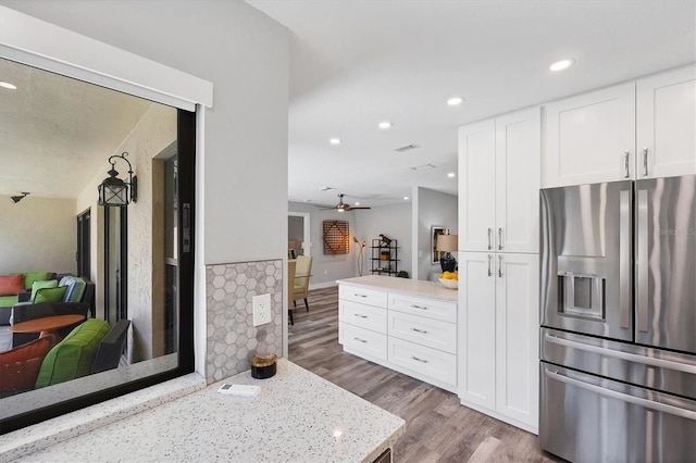 3955 Glen Oaks Manor Dr, Sarasota, FL 34232 - kitchen with stainless steel fridge, wood finished floors, a ceiling fan, white cabinets, and recessed lighting