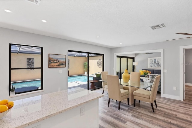 3955 Glen Oaks Manor Dr, Sarasota, FL 34232 - dining area featuring light wood-style floors, ceiling fan, recessed lighting, and a textured ceiling
